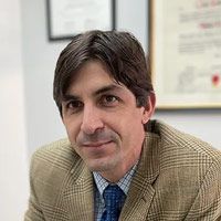 A man wearing glasses and a suit is in a circle.