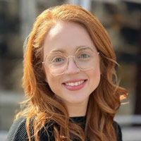 A man wearing glasses and a suit is in a circle.