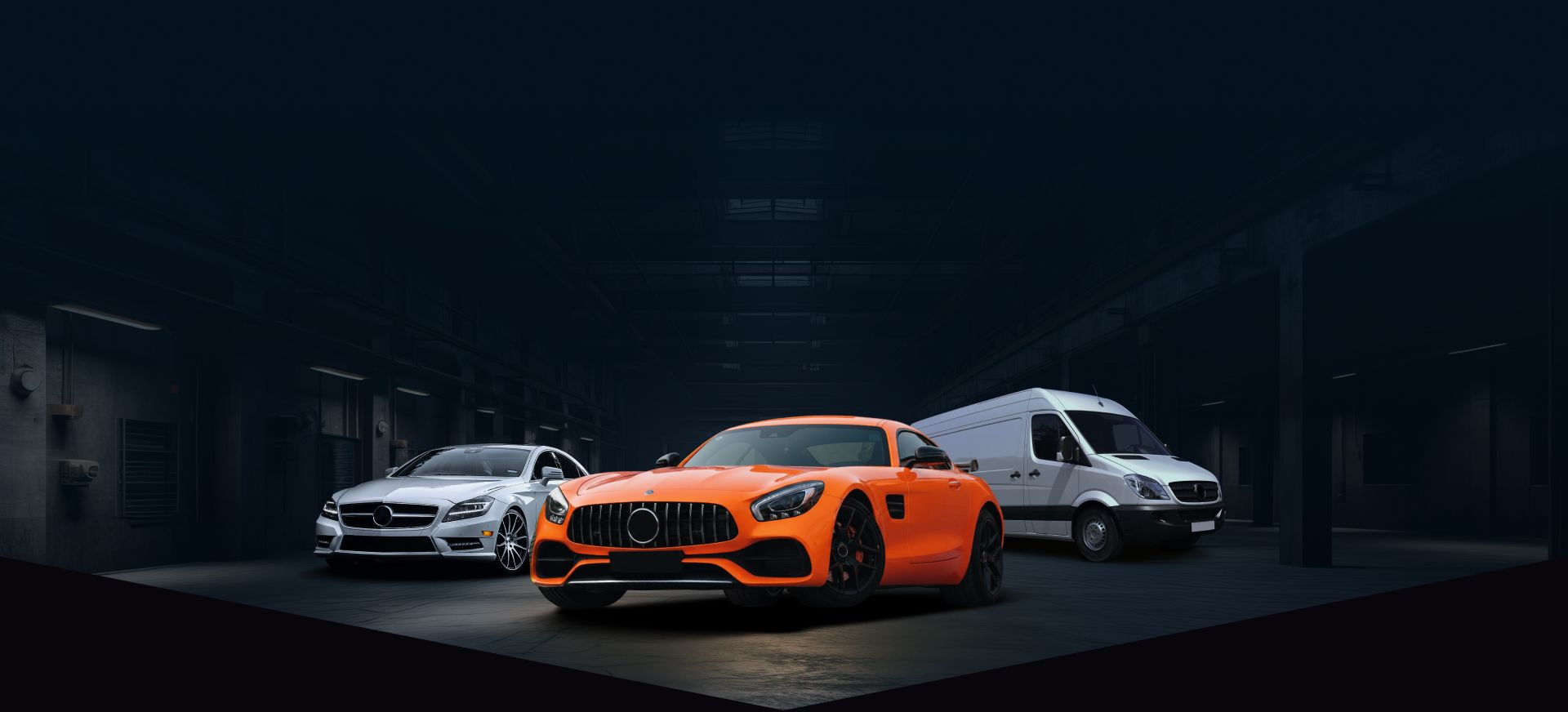 Three sports cars in a dark showroom, with an orange car centered between white cars. | Sam Smith Performance Car Care Center