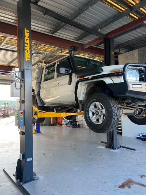 A Truck Is Sitting On A Lift In A Garage — Murphys Mobile Mechanical In Rockhampton, QLD