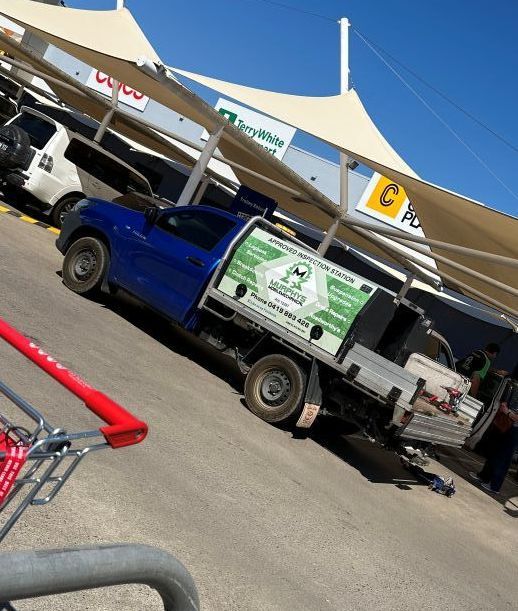 A Blue Truck Is Parked In A Parking Lot Next To A Shopping Cart — Murphys Mobile Mechanical In Rockhampton, QLD