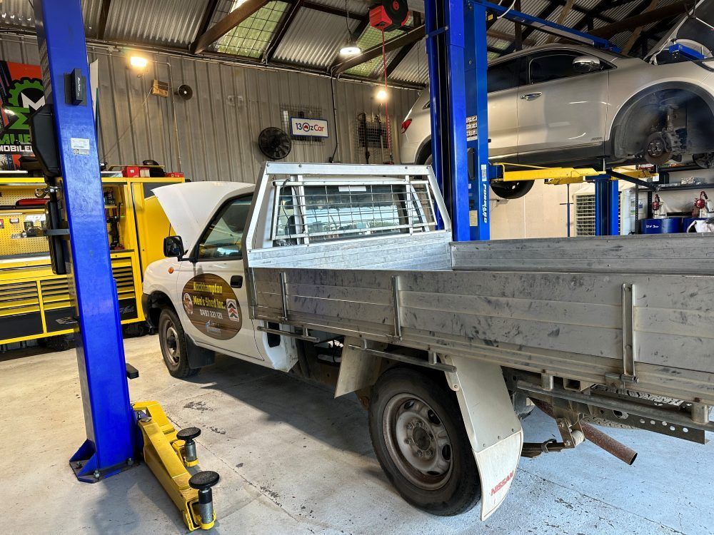 A Truck Is Sitting On A Lift In A Garage — Murphys Mobile Mechanical In Rockhampton, QLD
