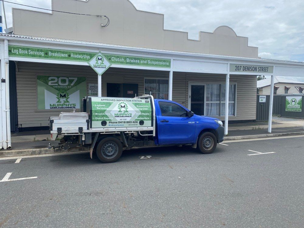 A Blue Truck Is Parked In Front Of A Building — Murphys Mobile Mechanical In Rockhampton, QLD