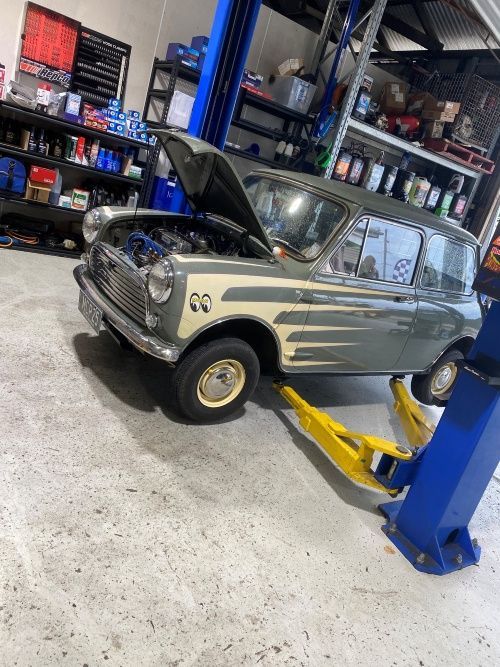An Old Car Is Sitting On A Lift In A Garage — Murphys Mobile Mechanical In Rockhampton, QLD