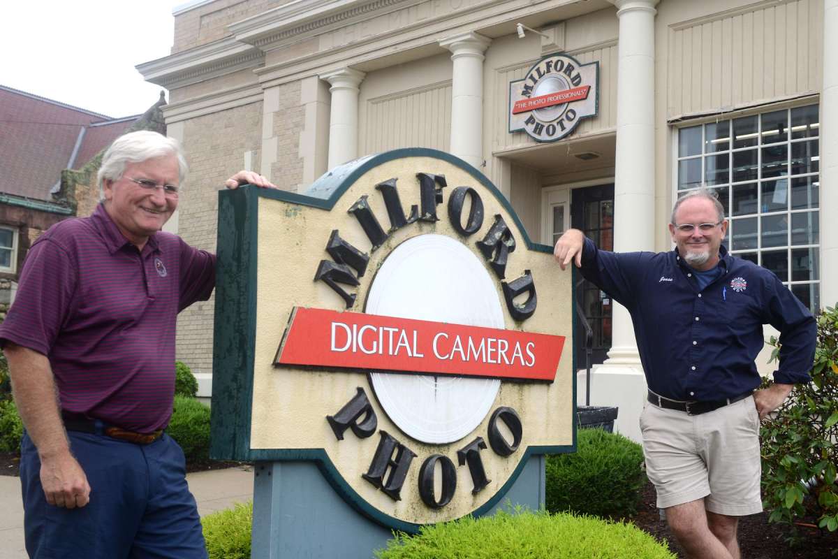 Founder Jim Wilson, left, and store manager and co-owner Jesse Thompson pose in front of Milford Photo, in Milford, Conn. Sept. 1, 2021.