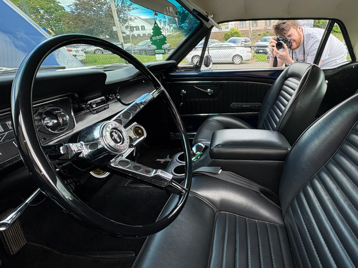 photographer sets up shot of classic car interior