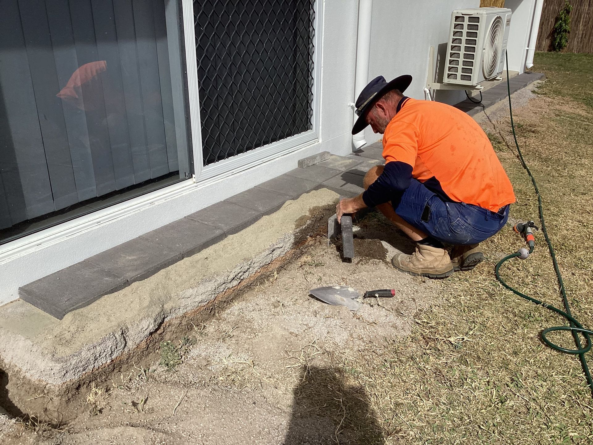 Handyman Installing pavers  outside the house— Handyman Services in Belgian Gardens, QLD