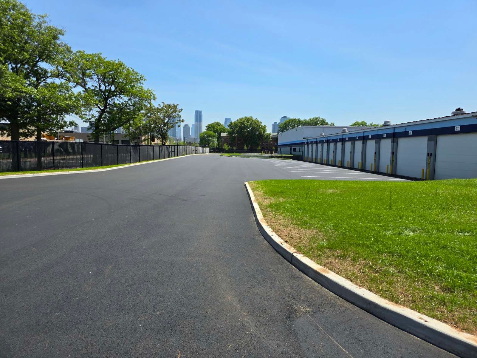 A row of garage doors are lined up on the side of a road
