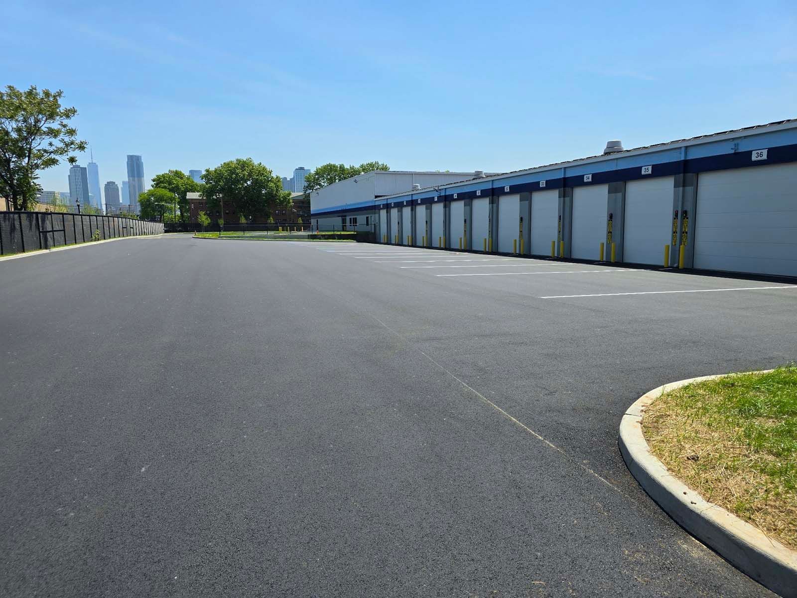 An empty parking lot with a building in the background