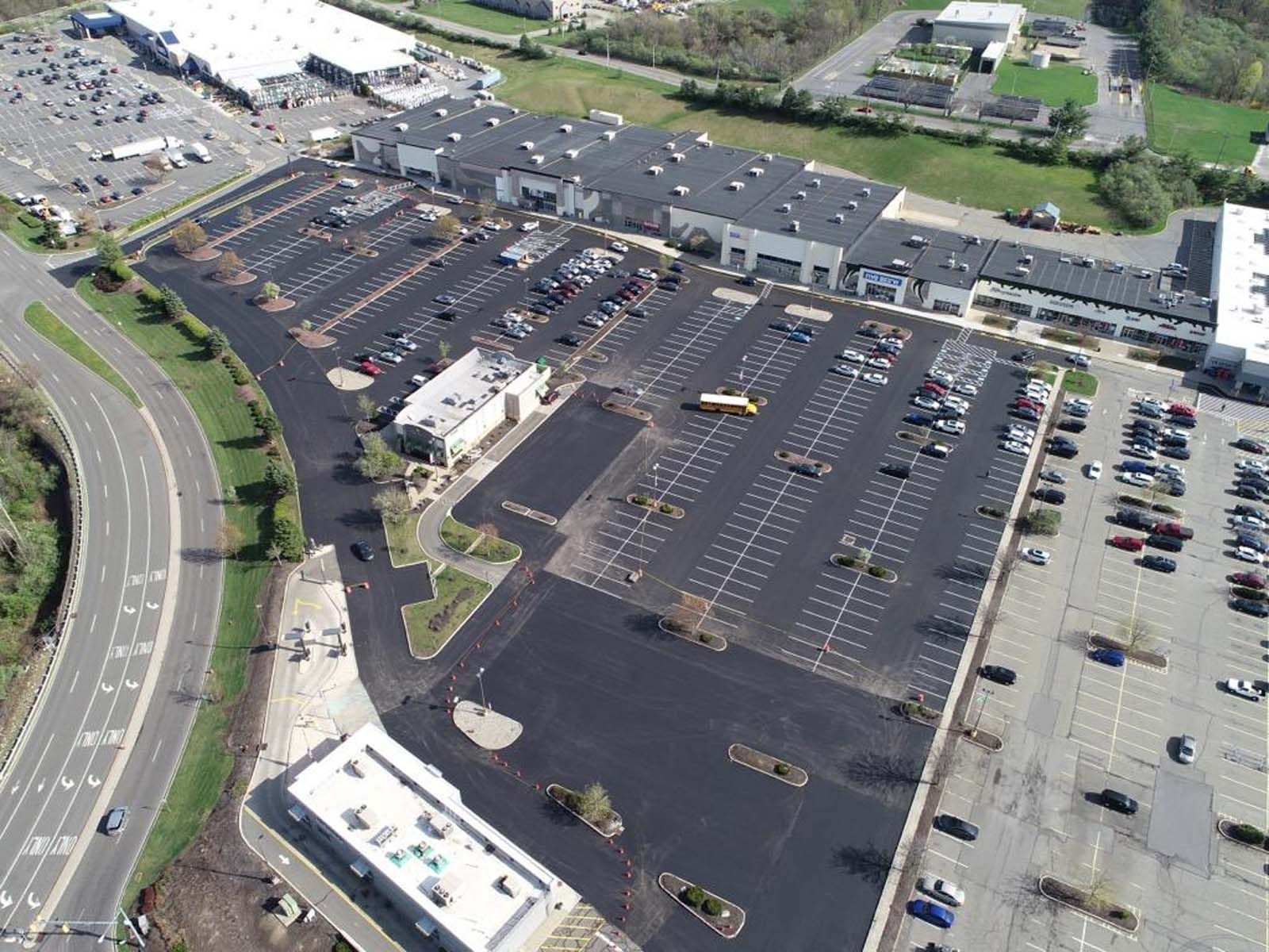 An aerial view of a parking lot with lots of cars parked in it