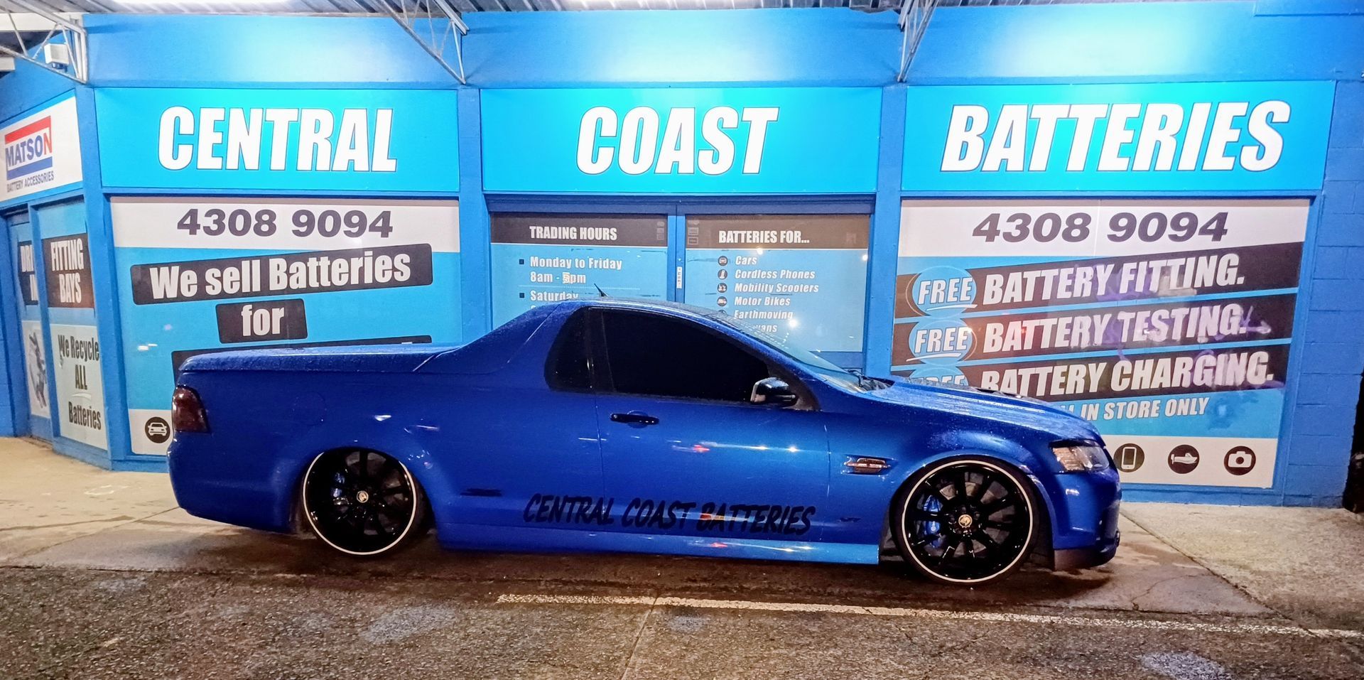 A Person is Plugging a Battery Into a Car With a Wrench — Central Coast Batteries In Long Jetty, NSW