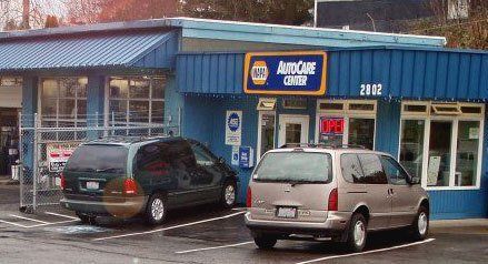 Two cars are parked in front of an autocare center | Quality Auto & Electric