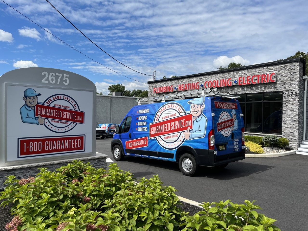 A blue van is parked in front of a building.