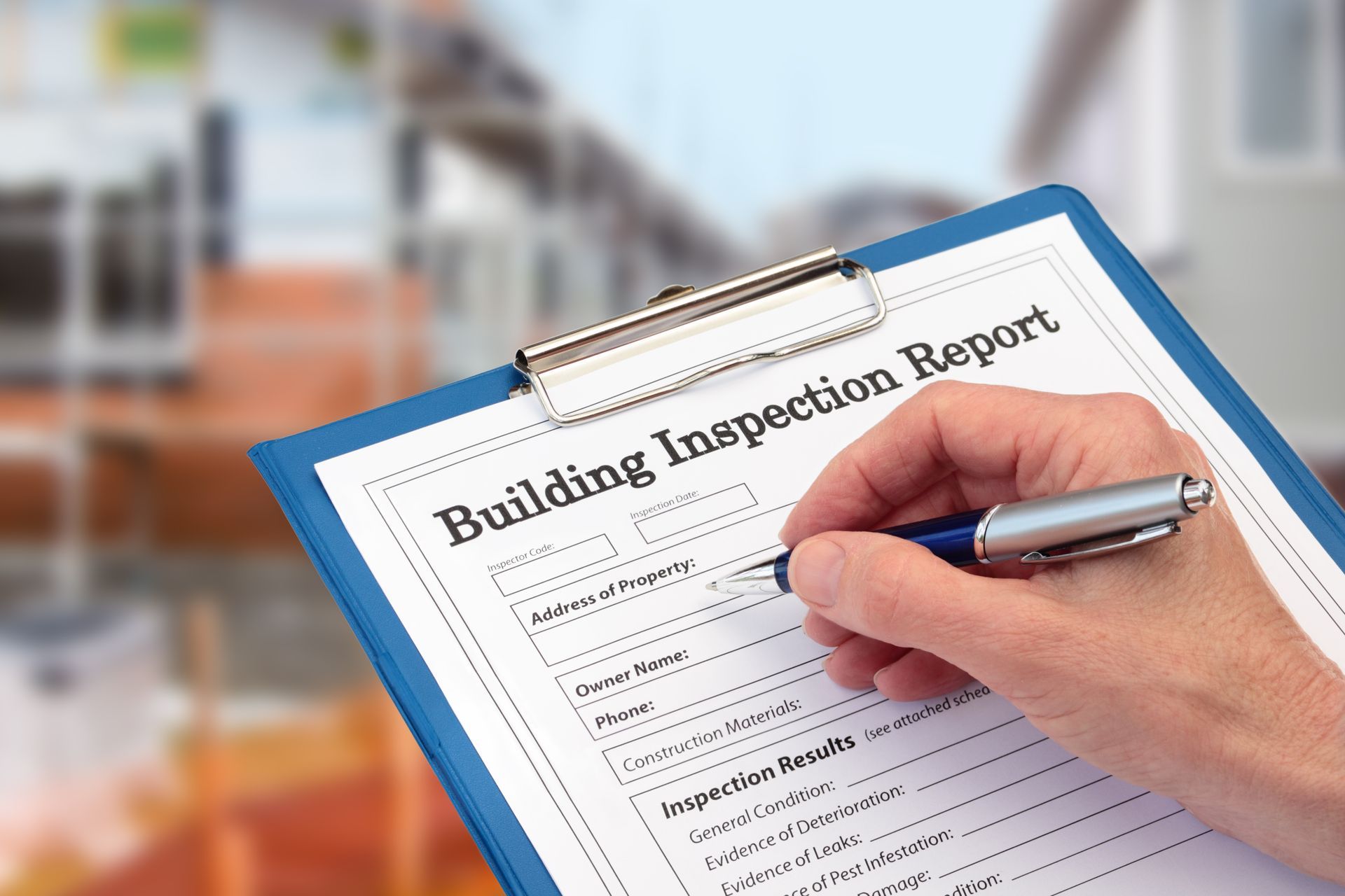a roofing inspector preparing to fill out information on his report paper