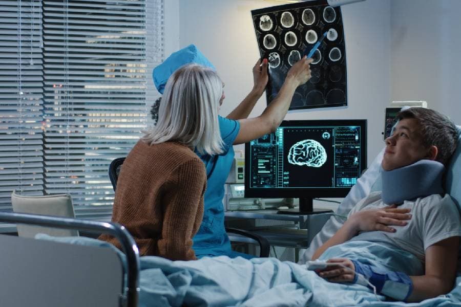 Doctor showing patient and family member brain scan 