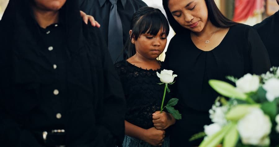 Family mourning loved one at funeral. 