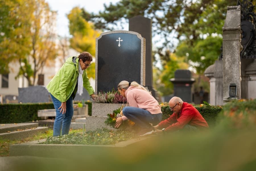 Family tending to a loved one’s grave