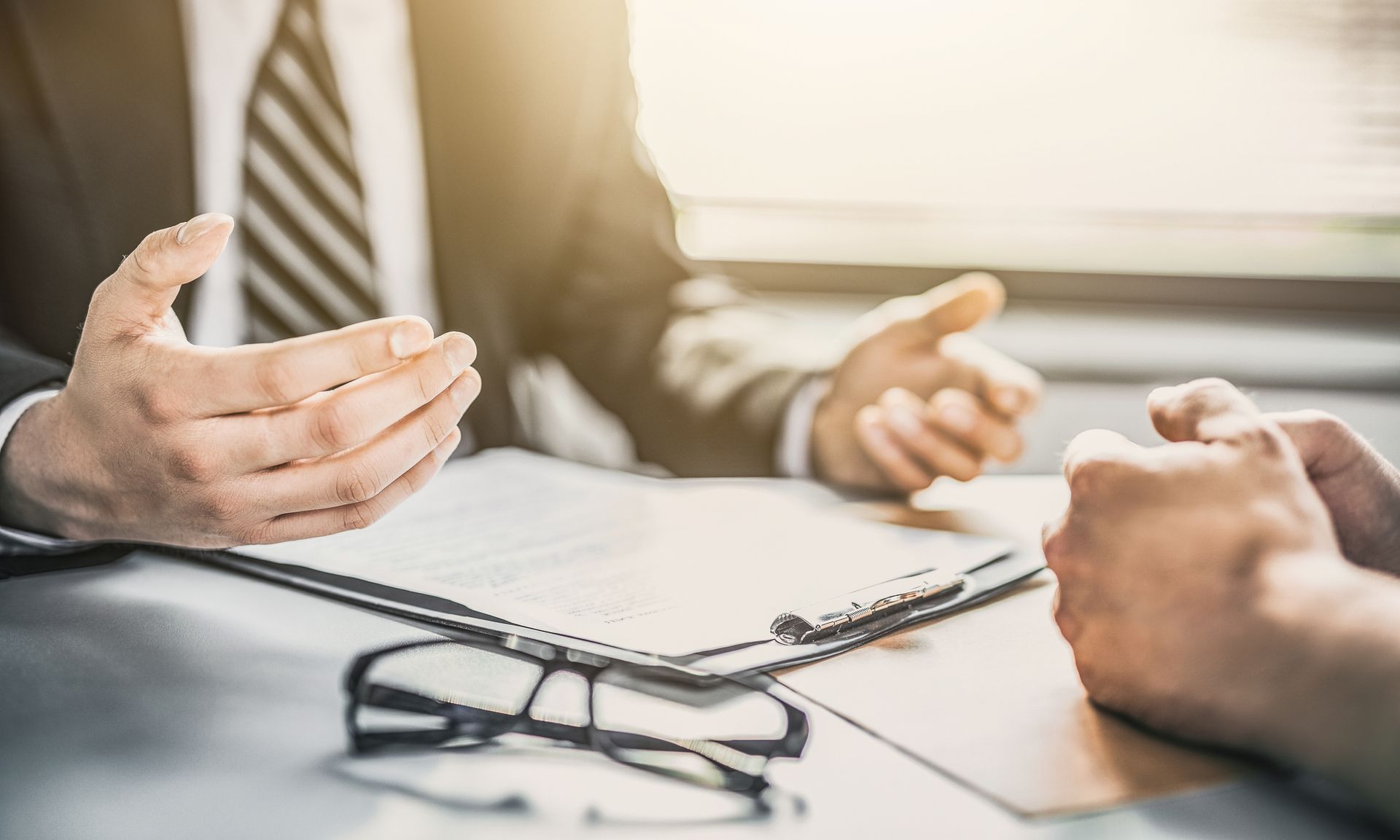 Close-up of an agent from a collection agency, discussing a tailored strategy with a client.