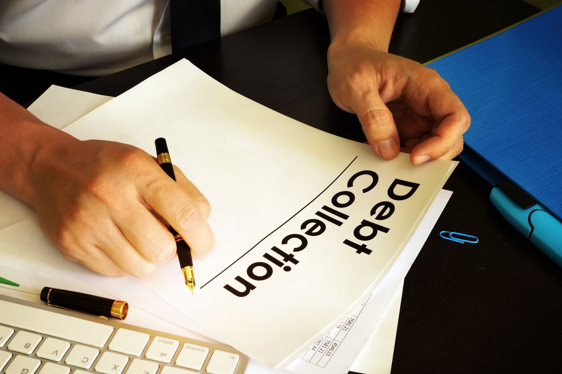 Manager at a debt collection agency holding documents in a modern office setting. Manager at a debt collection agency holding documents in a modern office setting.