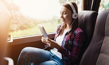 School Bus Transit — Girl Inside The Bus Holding Her Tablet  in Castroville, CA