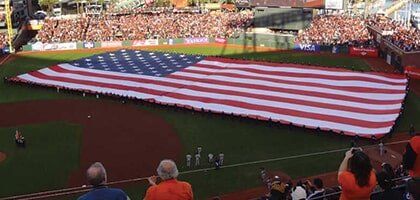 Large Group Travel — Huge Size Of American Flag In Baseball Field in Castroville, CA Large Group Travel — Huge Size Of American Flag In Baseball Field in Castroville, CA