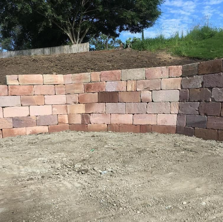 A Brick Wall with A Tree in The Background — Webster Rock Walls In Caboolture, QLD