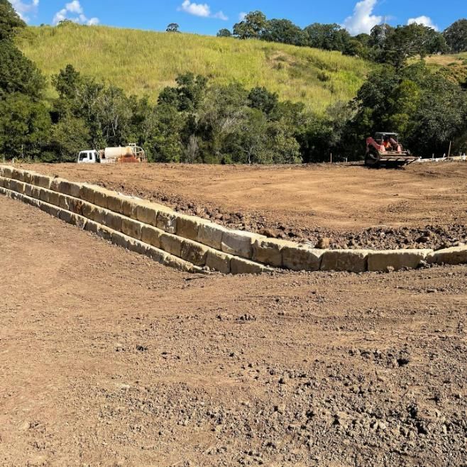 A Construction Site with A Bulldozer in The Background — Webster Rock Walls In Caloundra, QLD