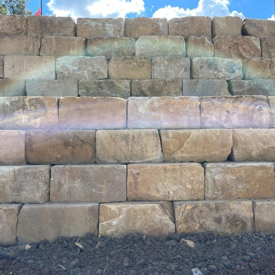 A Brick Wall with A Blue Sky in The Background — Webster Rock Walls In Gympie, QLD