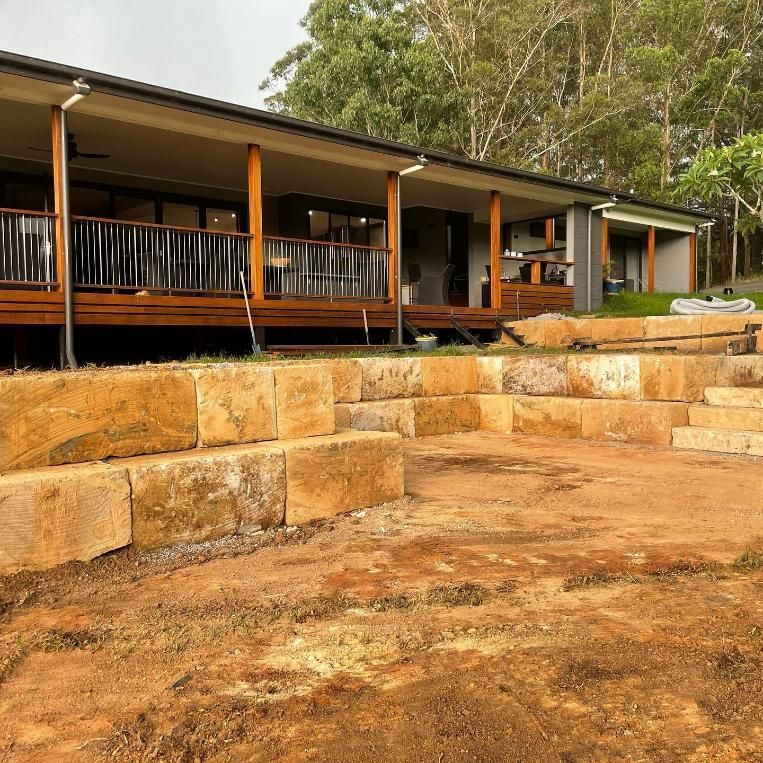 A House with A Large Porch and Stairs in Front of It — Webster Rock Walls In Maroochydore, QLD