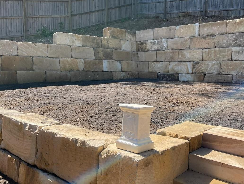 A Stone Wall with Stairs and A Statue in The Middle of It — Webster Rock Walls In Gympie, QLD