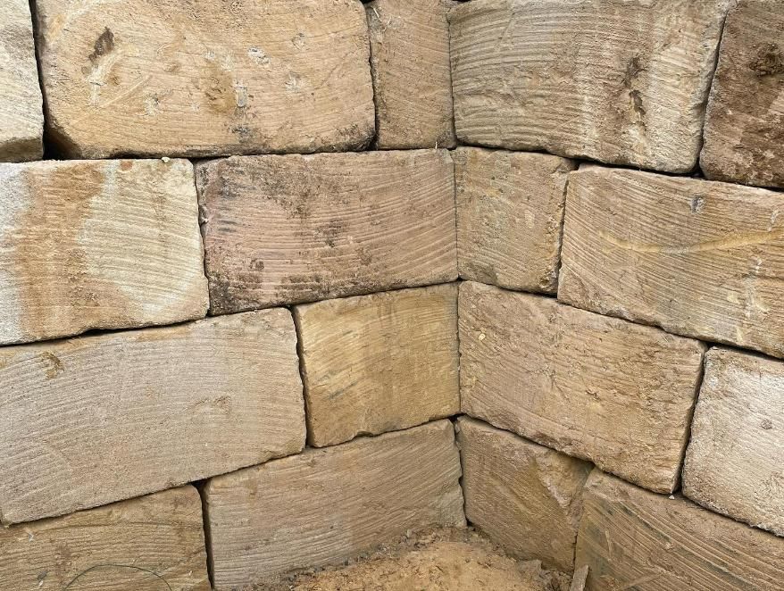 A Brick Wall with A Lot of Bricks Stacked on Top of Each Other — Webster Rock Walls In Ilkley, QLD