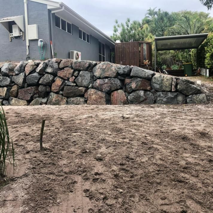 A Large Rock Wall in Front of A House — Webster Rock Walls In Ilkley, QLD