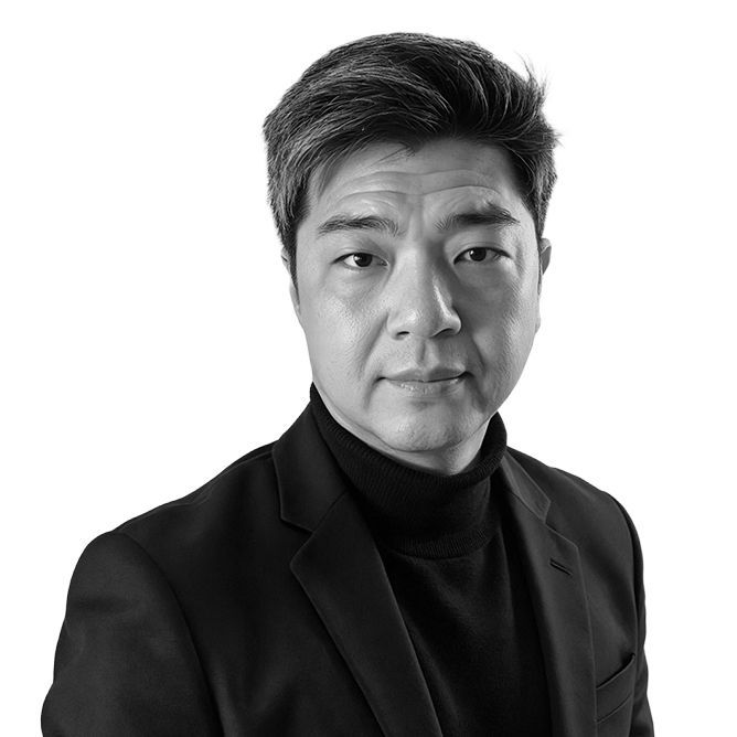 Man in blazer and turtleneck, looking forward. Black and white portrait.