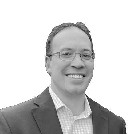 Man in blazer and turtleneck, looking forward. Black and white portrait.