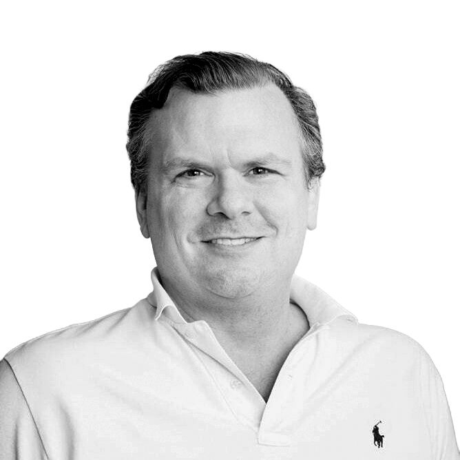 Man smiling, wearing a white polo shirt, against a white background.