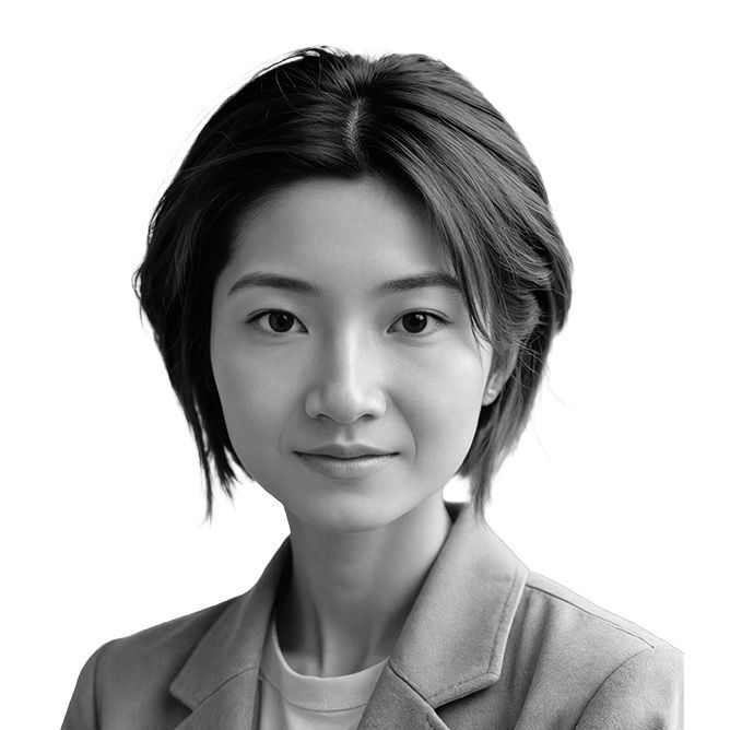 Woman with short dark hair in a light-colored blazer looking at the camera.