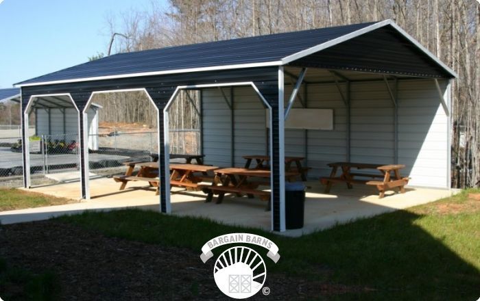 A covered area with picnic tables underneath it