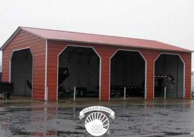 A red garage with a white trim and a red roof