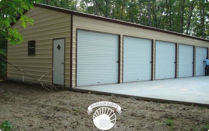 A man stands in front of a garage with white doors