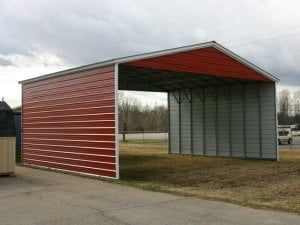 A red and white metal garage is sitting on the side of a road.