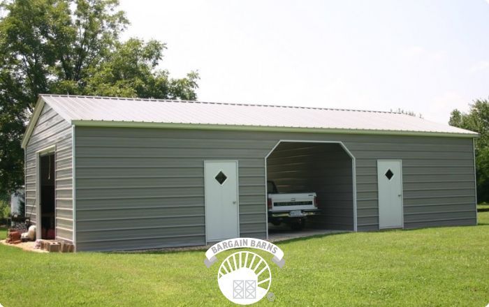 A gray garage with a white truck parked inside of it