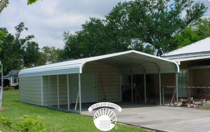 A white carport is sitting in front of a house