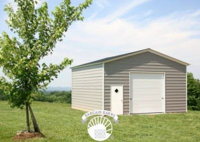 A garage with a white door and a tree in front of it.