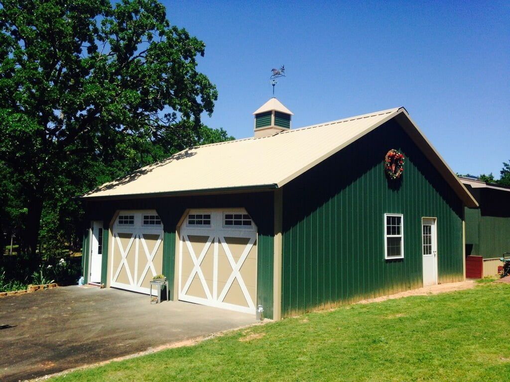 A green barn with white x 's on the doors
