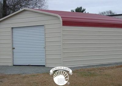 A white garage with a red roof and a white door