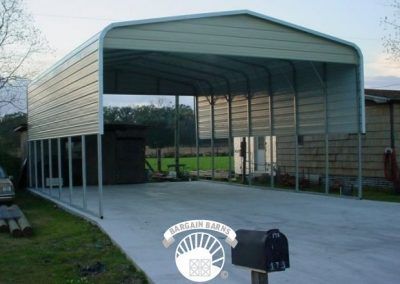A carport with a mailbox in front of it
