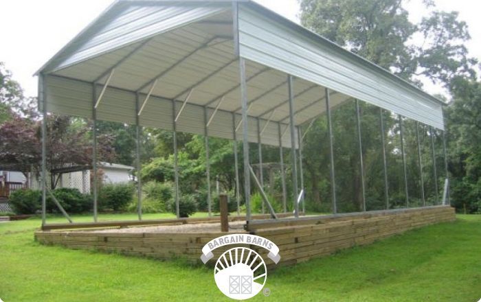 A large metal structure is sitting in the middle of a lush green field.