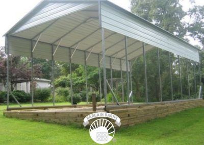 A large metal structure is sitting on top of a lush green field.