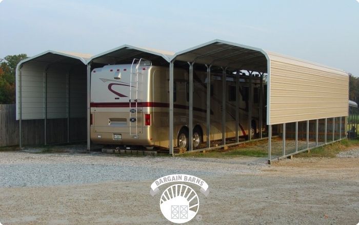 A rv is parked under a canopy in a parking lot