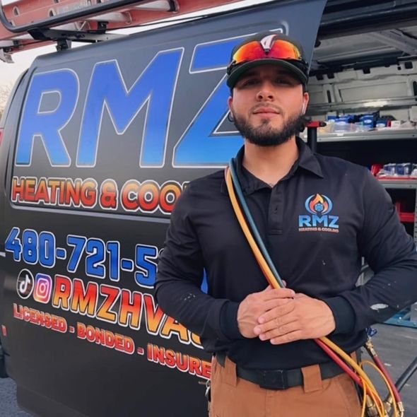 A man standing in front of a rmz heating and cooling van